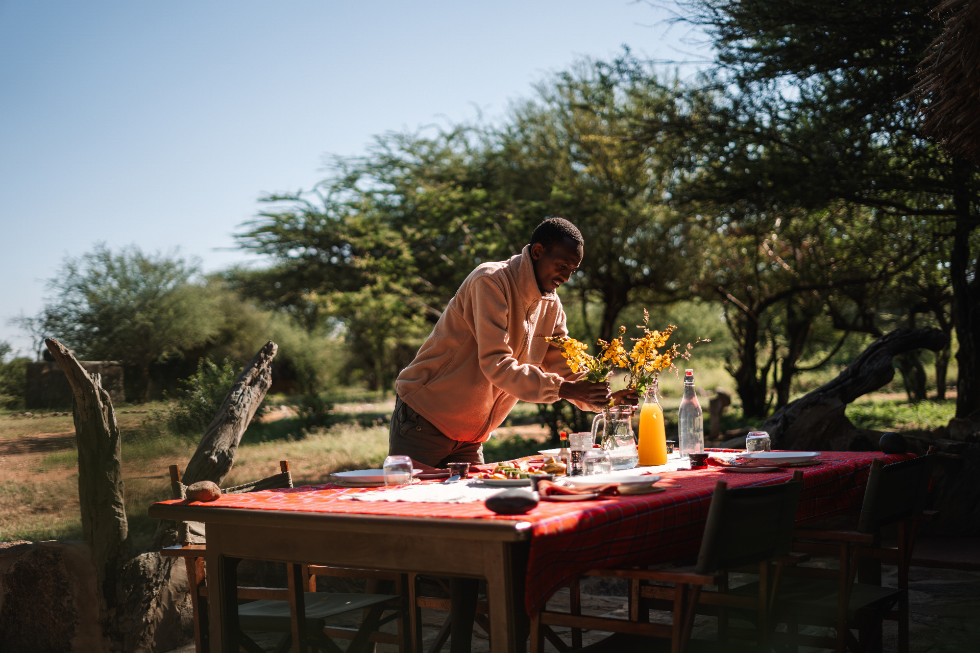 Front of house team member arranging flowers on the breakfast table